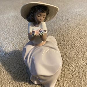 Beautiful girl figurine holding flowers